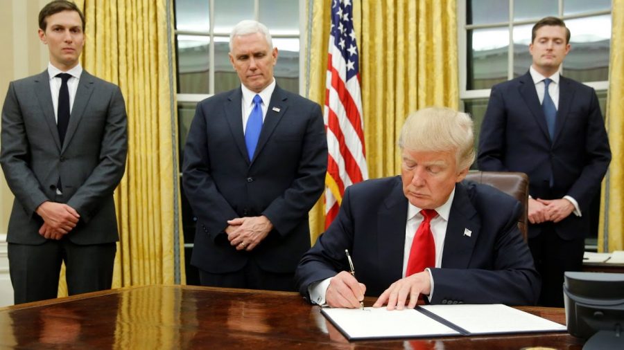Donald Trump signs the first of many laws repealing Obamacare.