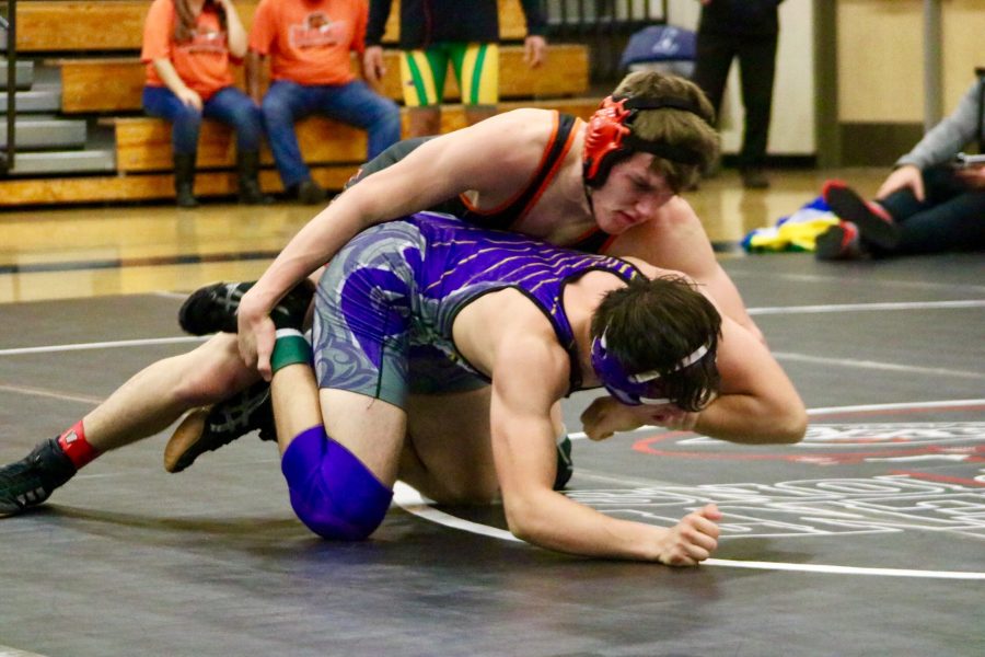 Junior Aaron Hall attempts to pin his opponent from Sunset High School.