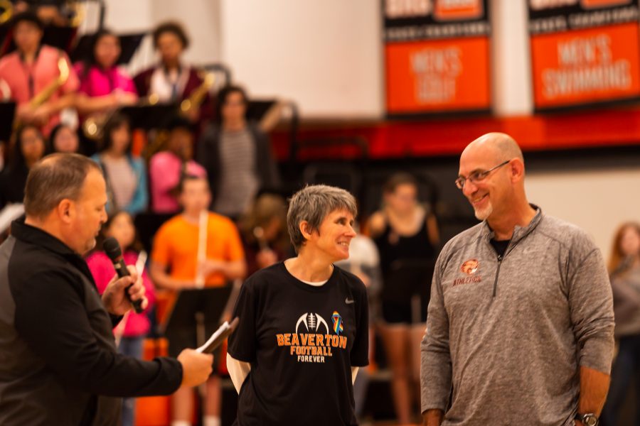 Coach Boyer receives his award at the homecoming assembly.