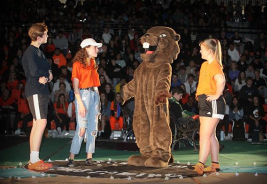 Leadership students talk with Bucky the Beaver at the 2019 Homecoming Assembly.