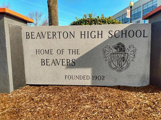 The sun shines on the BHS sign at the entrance of the main school parking lot.