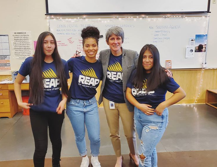 Beaverton High School principal Dr. Anne Erwin stands with members of the REAP Solutions program.