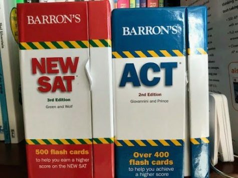 A set of SAT and ACT prep flashcards sit on a table.
