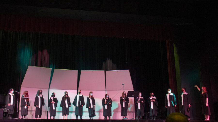 Director Kelly Hefty presents the Concert Choir as they finish their song.