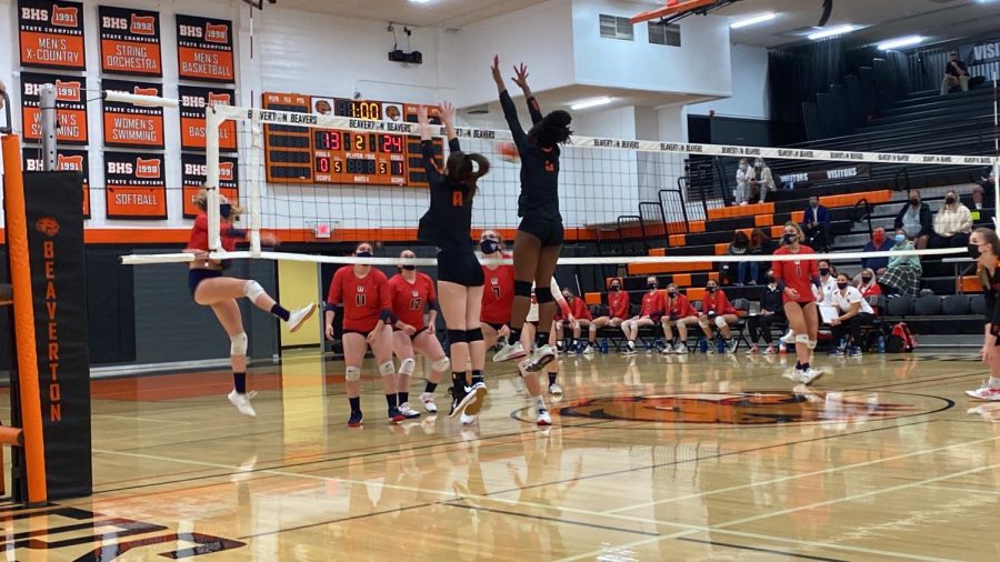 Varsity volleyball players Peyton Coleman and Amariah Clay jump to meet the ball during last Thursday's game against Westview.