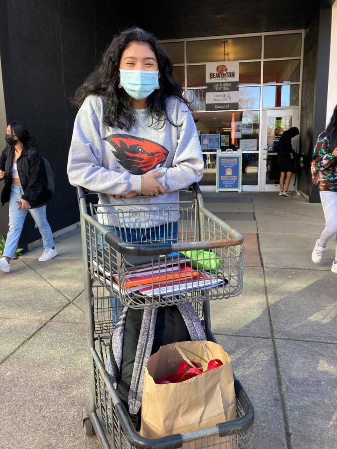 Sophomore Maria Kraske carries her belongings in a shopping cart.