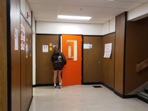 A student enters the girls locker room. Recently, a dress code policy banning tank tops in PE has become controversial in some classes.