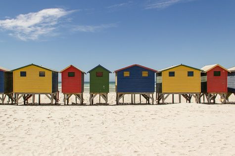 Houses line a beach in South Africa. Beach Houses Muizenberg Beach by Stefan Schäfer, Lich is licensed under CC BY-SA 3.0. 