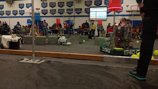 A chaotic mid-match scene at the BunnyBots robotics competition. 