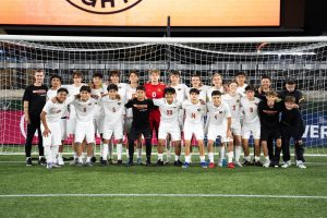 The boys varsity team poses for a picture after playing Parkrose at Providence Park. 